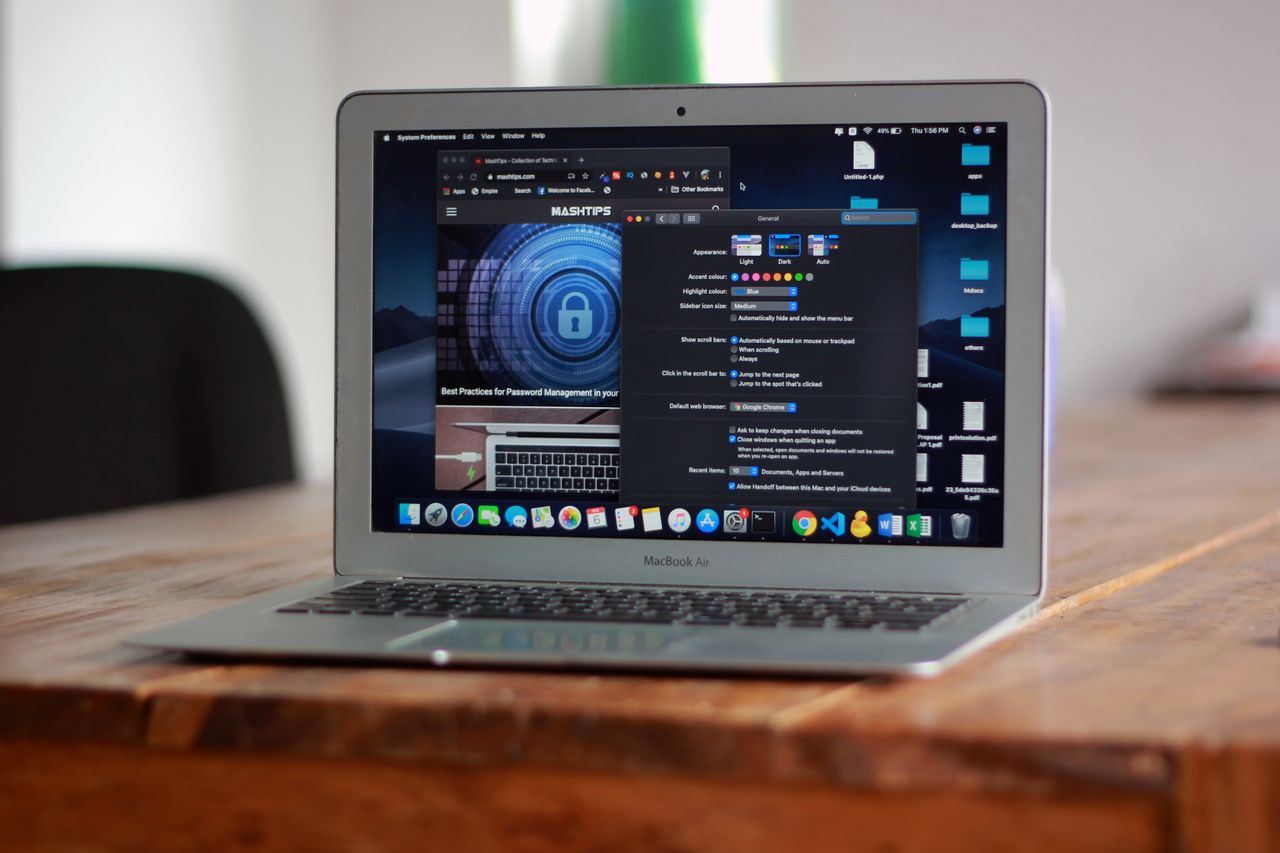 Home Open MacBook Air with apps and web browser on screen, placed on a wooden table indoors.